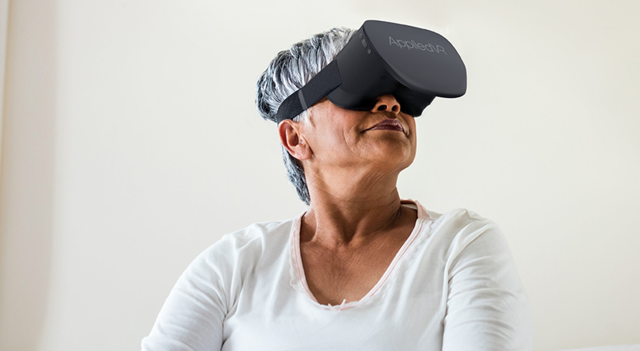 Patient wearing VR headset used to treat low back pain