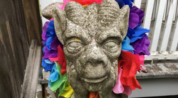 Gargoyle statue with Pride scarf.