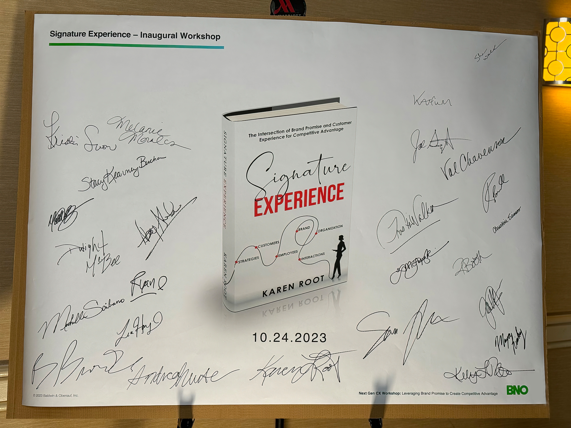 A signed poster of Karen Root’s newly published book, Signature Experience: The Intersection of Brand Promise and Customer Experience for Competitive Advantage.