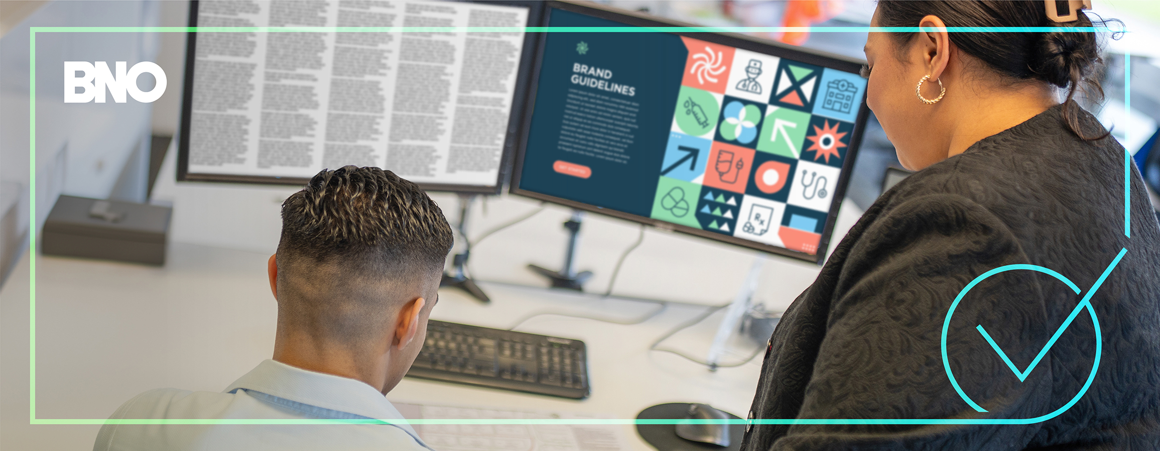 Two people looking at brand guidelines in copy.
