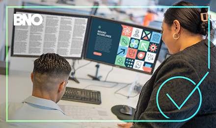 Two people looking at brand guidelines in copy.